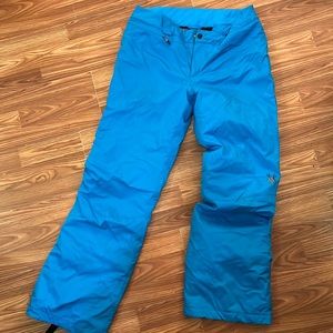 Bright blue insulated snow pants .